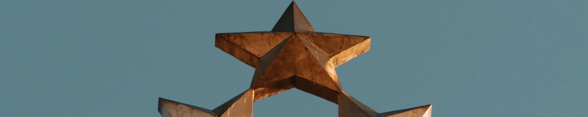 Gold metal stars against a blue sky